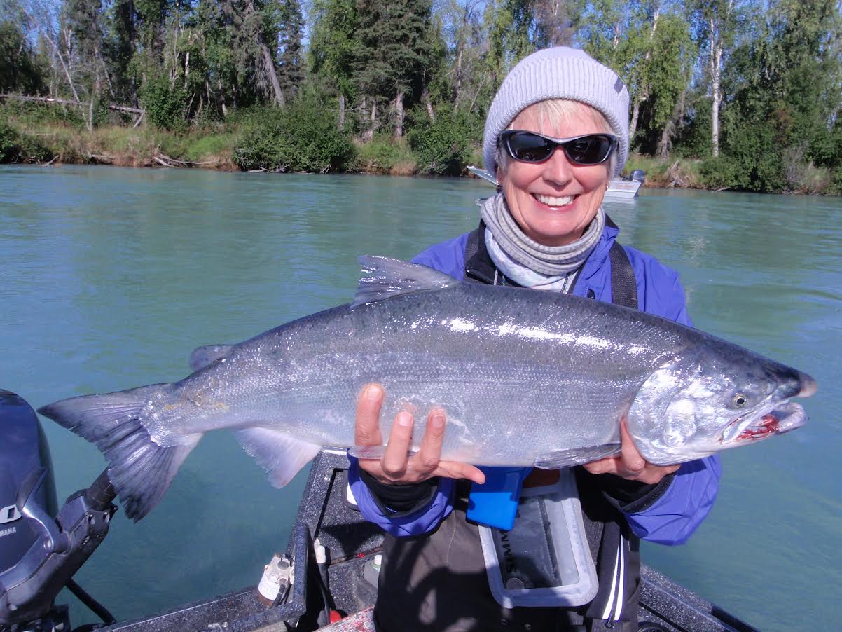 Woman holding a silver salmon.