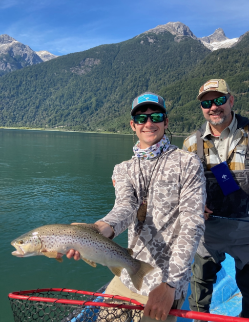 Father and son posing with a trout.