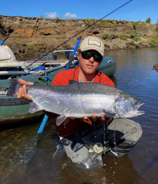 Guide in the water holding trophy fish.