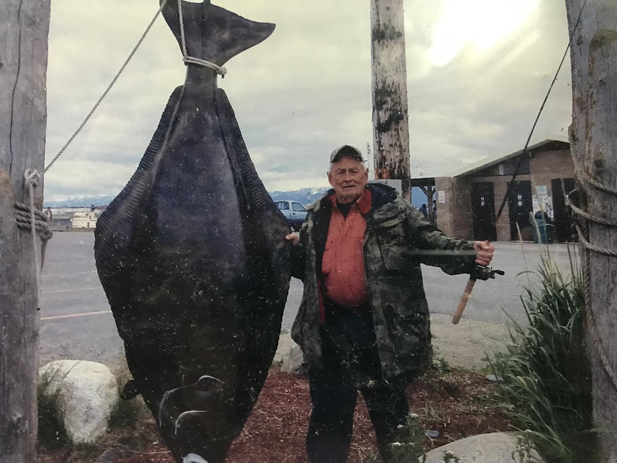 Man posing with a halibut.