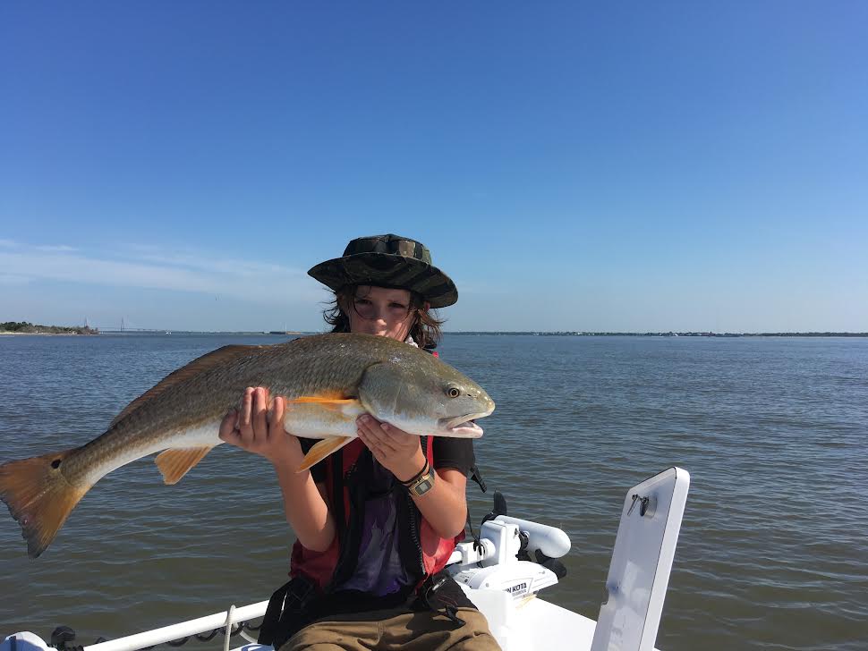 Kid holding a monster fish.