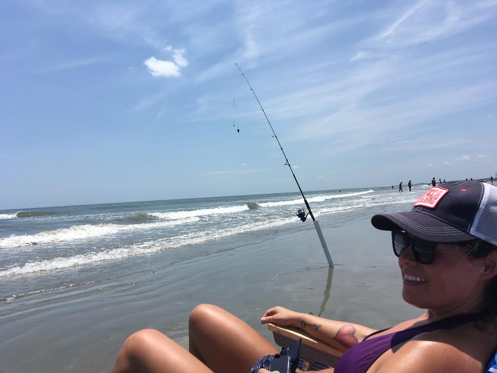 Woman surf fishes in he chair.