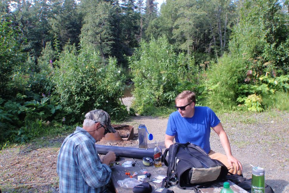 Father and son at a picnic table.