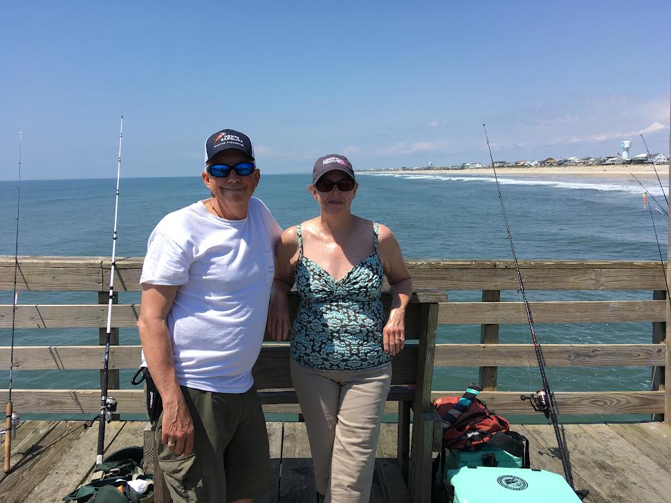 Wife and husband posing on the pier.