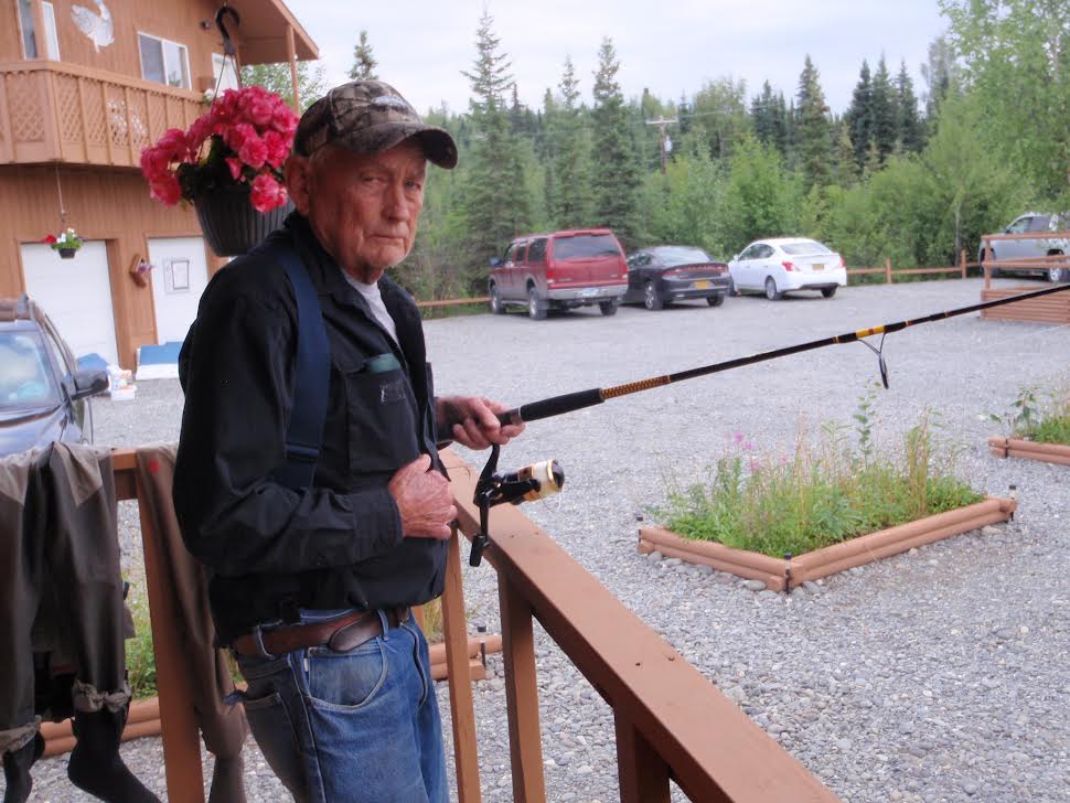 Grumpy old man holding fishing poll.