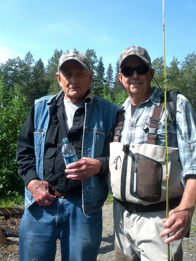 Father and son posing for a picture.